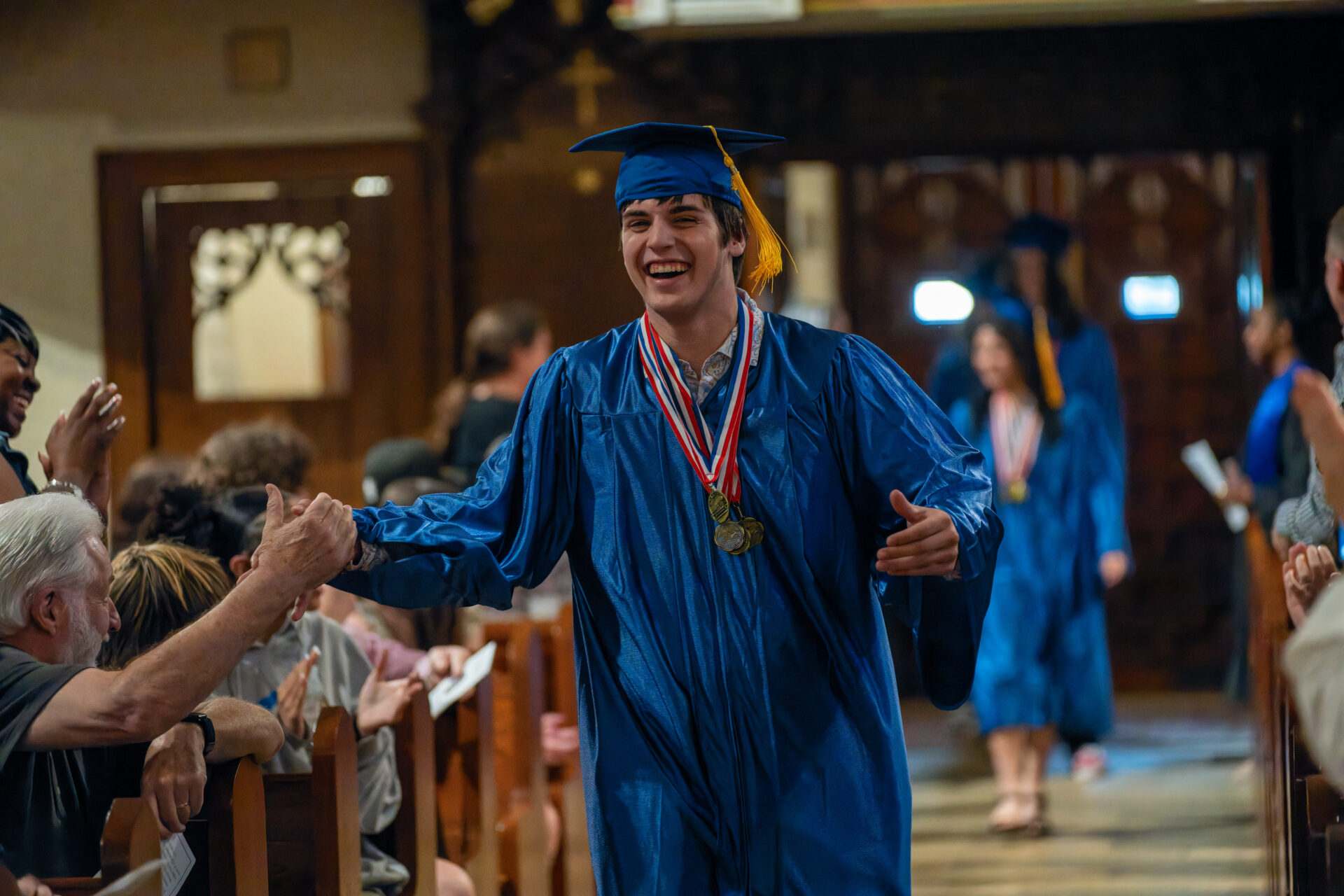 walking down isle at archway graduation