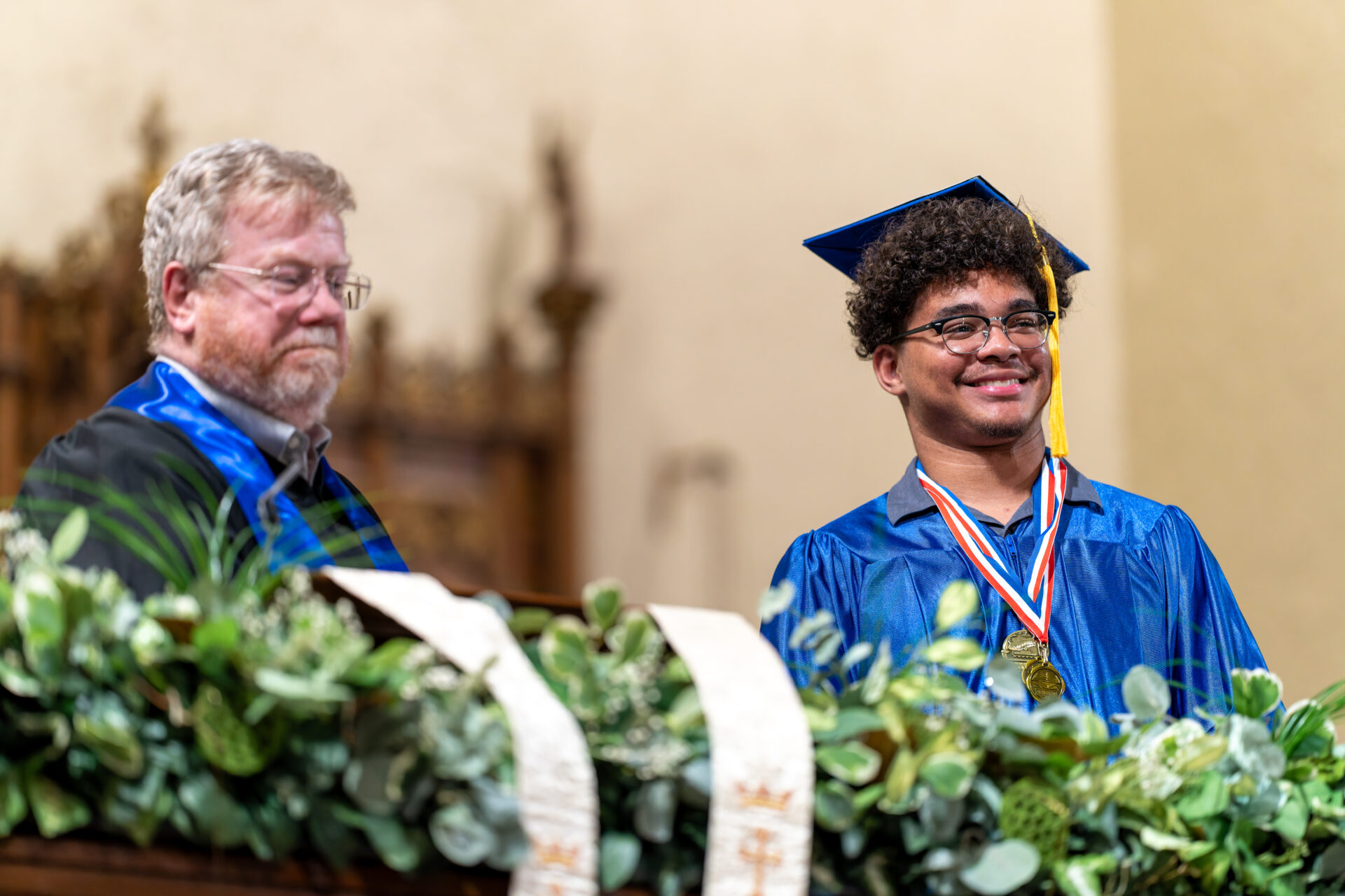 student and teacher at archway graduation